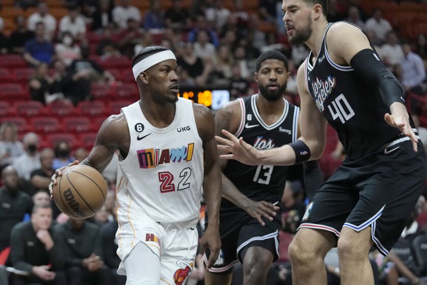 Miami Heat forward Jimmy Butler (22) drives past LA Clippers center Ivica Zubac (40) and forward Paul George.